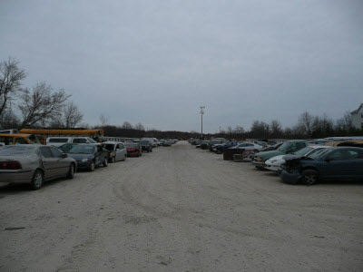 Wisconsin auto recycling facility in Milwaukee displays giant lot of used automobiles ready for auto salvage. 